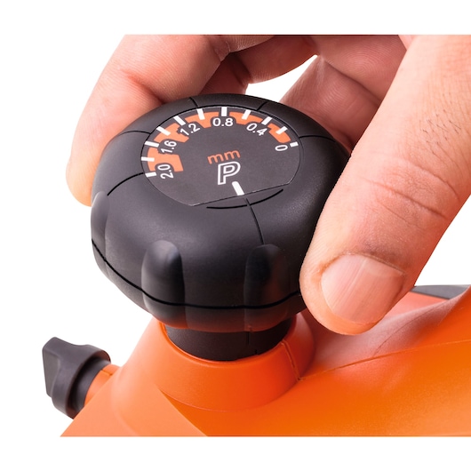 Photo of BLACKDECKER 7698 tool adjustment knob with millimeter scale, close-up with hand turning dial.