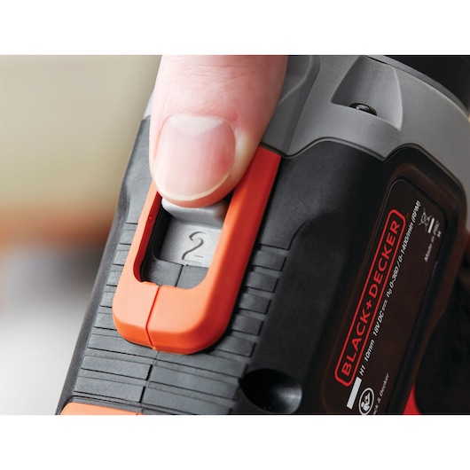 Photo of BLACK+DECKER BCK21S1S power tool speed selector being adjusted with a finger, close-up view.