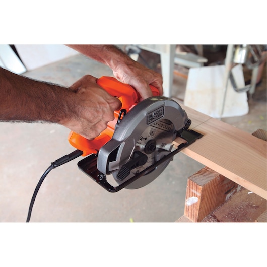 Photo of BLACKDECKER CS1004 circular saw cutting wood, close-up view of tool in use.