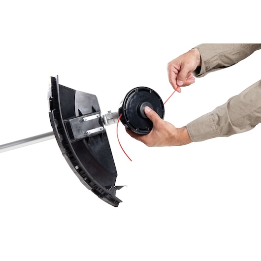 Photo of hands installing line on BLACKDECKER GST43 string trimmer head, close-up on white background.