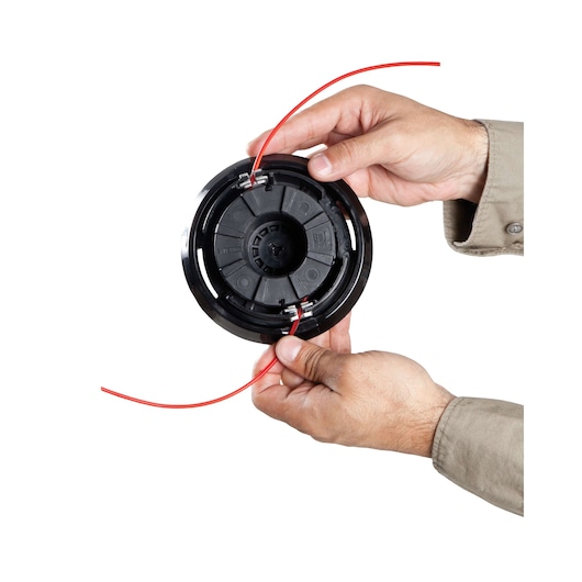 BLACKDECKER GST43 trimmer spool with red line, held by two hands, close-up on white background.