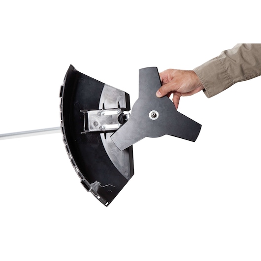 BLACKDECKER GST43 grass trimmer blade attachment held by hand, close-up on white background.