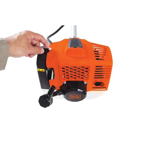 Photo of a BLACK+DECKER GST43 orange trimmer engine close-up, hand adjusting control, white background.